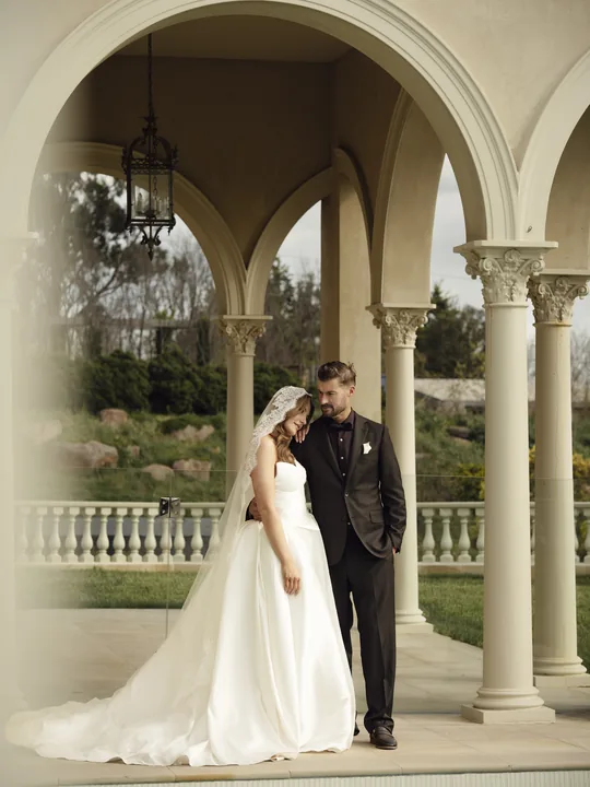 Only May Photography Melbourne wedding photography Bride and groom under a columned archway, wedding photography by Only May Photography, Melbourne